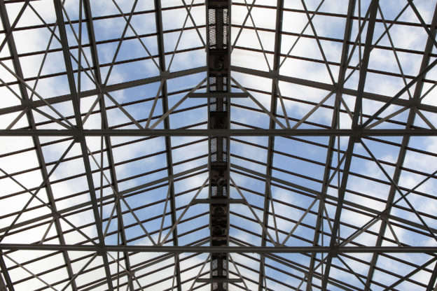 Metal frame and cloudy blue sky in the background view looking up